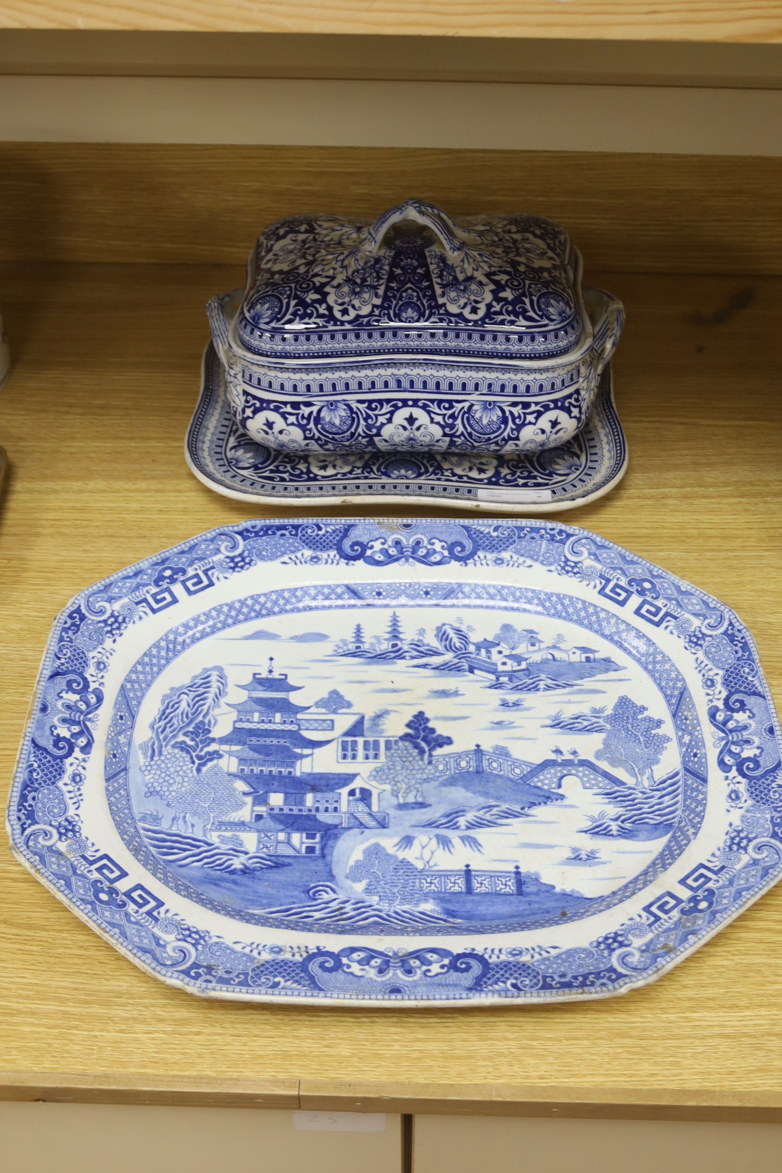 A blue and white meat dish decorated with a Chinese landscape pattern, and a Victorian blue and white tureen, cover and stand, height 17cm